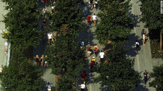 Visitors walk through the grounds of the National September 11 Memorial & Museum on Friday.