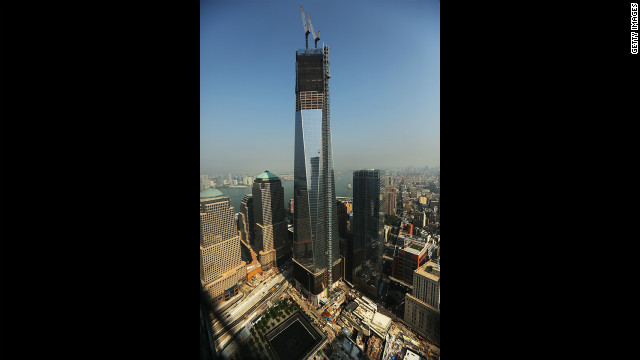 The progress of the construction on One World Trade Center can be seen in this photo, as well as one of the pools of the memorial site below.